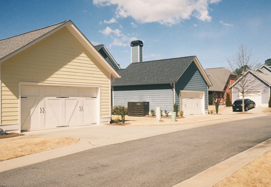Two asphalt driveway aprons meeting the edge of a residential street
