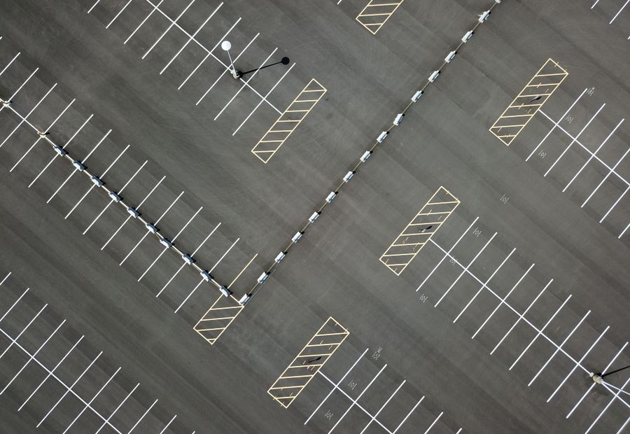 Overhead view of a newly paved commercial lot with fresh white stall striping